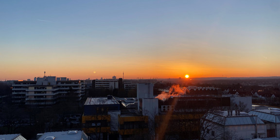 The image shows a beautiful sunrise above TU Dortmund University taken by Nadine Niesert.