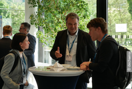 The image shows Norbert Kockmann in a discussion.