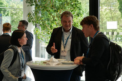The image shows Norbert Kockmann in a discussion.
