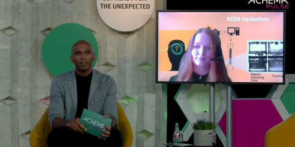 The image shows Laura Neuendorf talking about the KEEN Hackathon @ Achema Pulse 