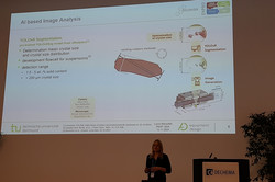 The image shows Laura Marsollek during her talk at the PEMT.