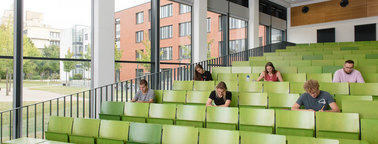 Students are sitting in a lecture hall.